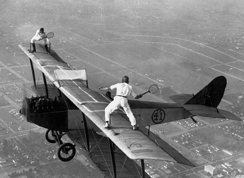 playing-tennis-on-wings-of-plane-vintage-daredevils-black-and-white